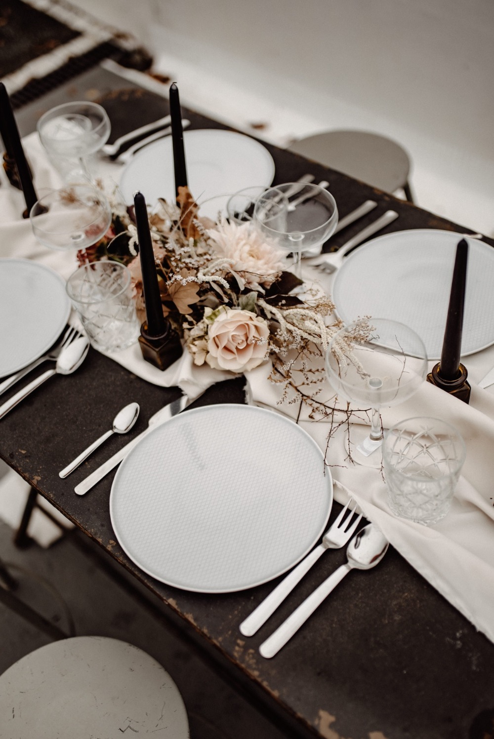Elegant dining table setting with flowers and candles for event
