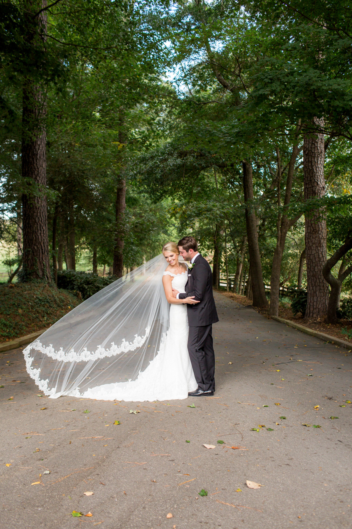 Bride and groom embrace outdoors on their wedding day