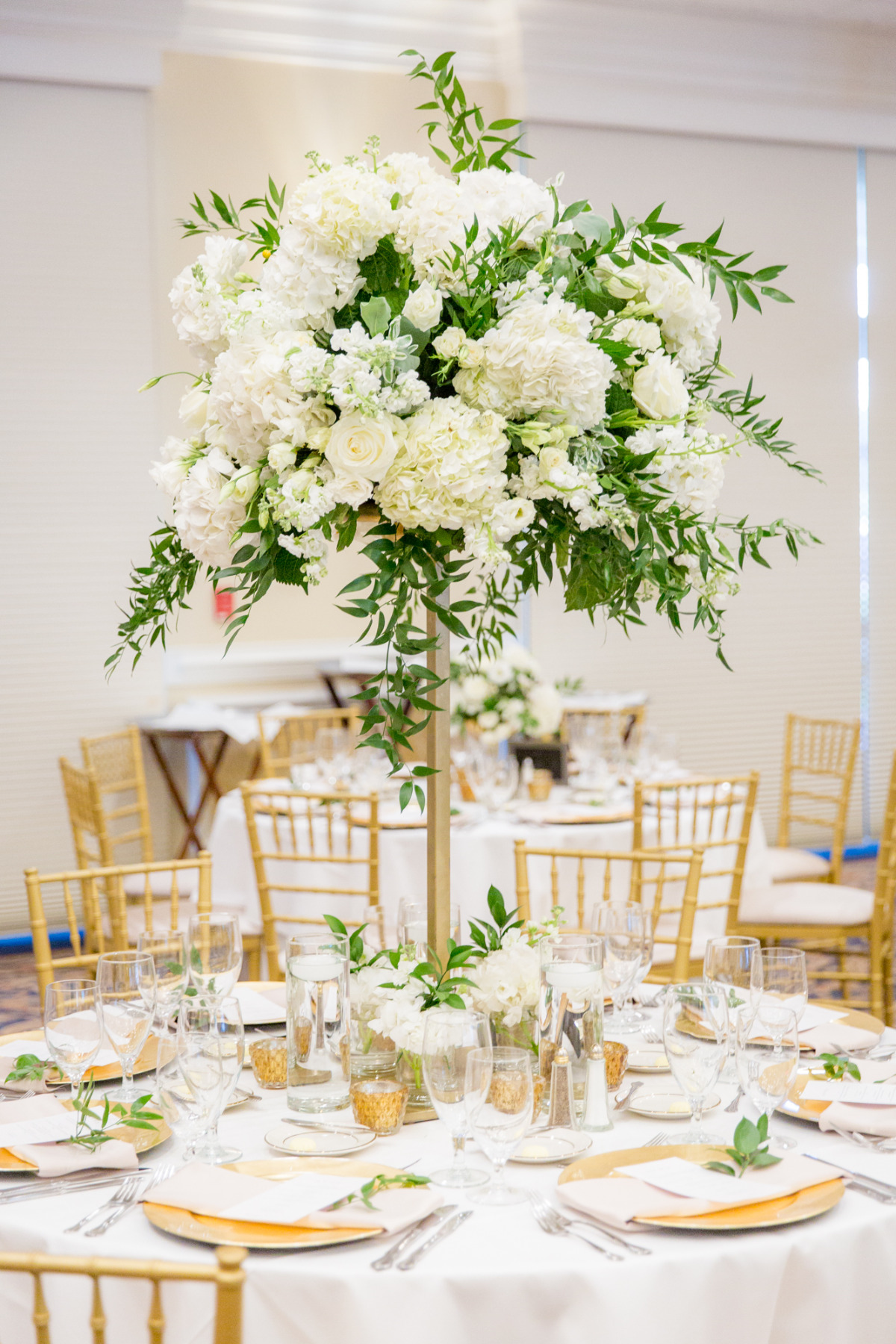 Elegant white floral centerpiece on wedding reception table