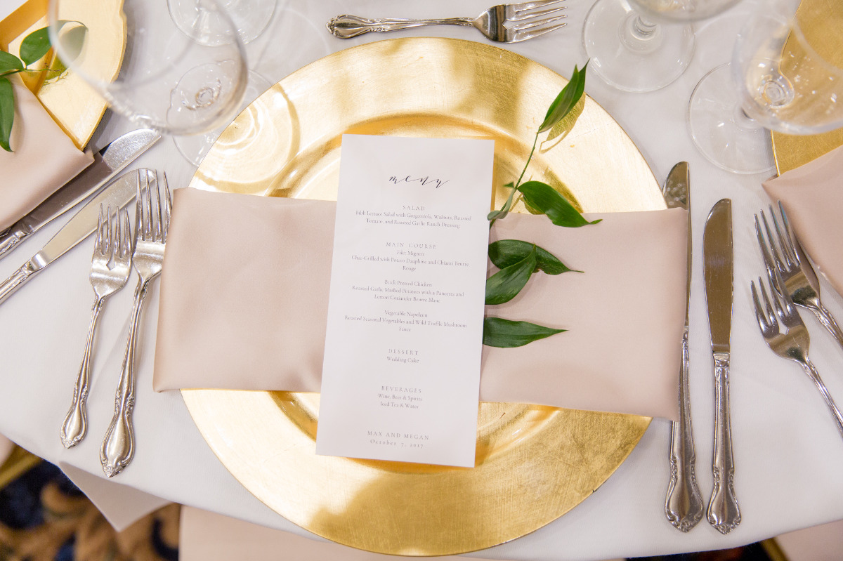 Elegant wedding place setting with menu card and gold charger