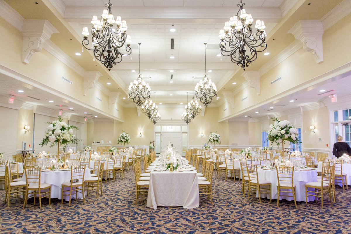 Elegant wedding reception venue with chandeliers flowers