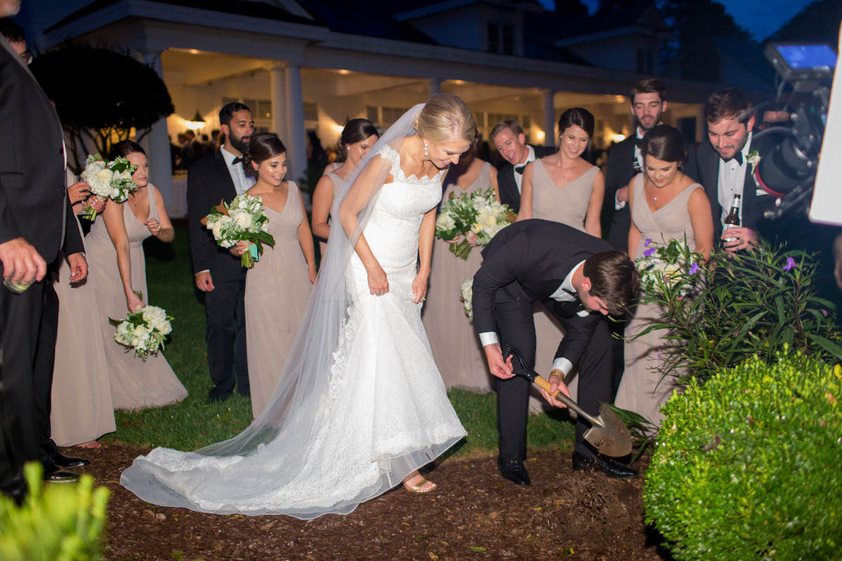 Bride and groom participate in tree planting ceremony