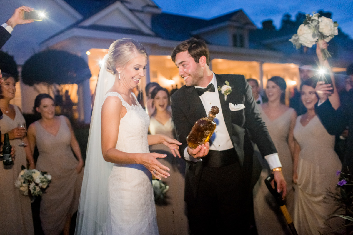 Bride and groom celebrate wedding with tequila shot