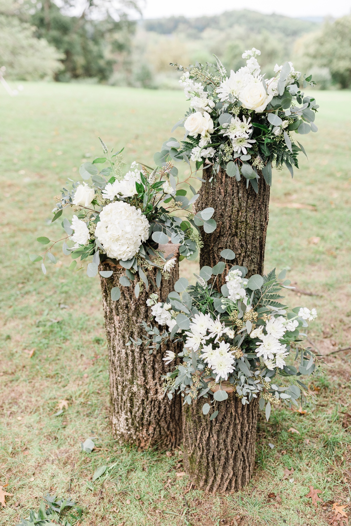rustic stump and floral accents for wedding ceremony backdrop