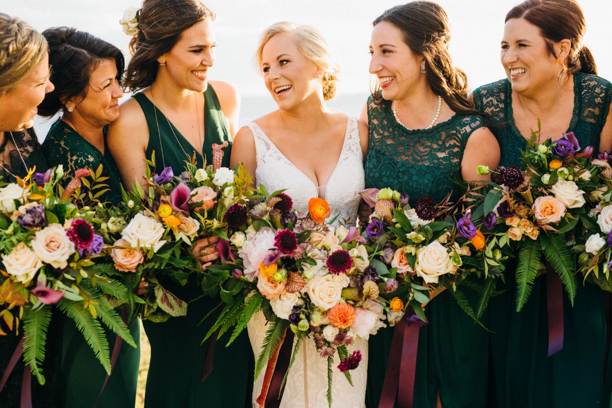 Bridesmaids in emerald lace dresses