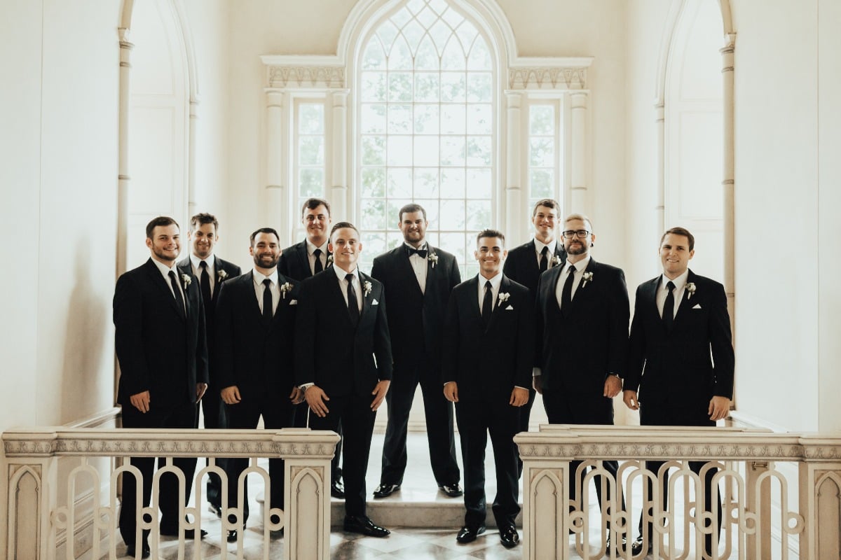 groom and groomsmen in black suits and ties