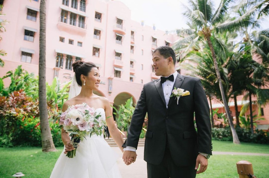Happy couple holding hands, wedding day at a resort