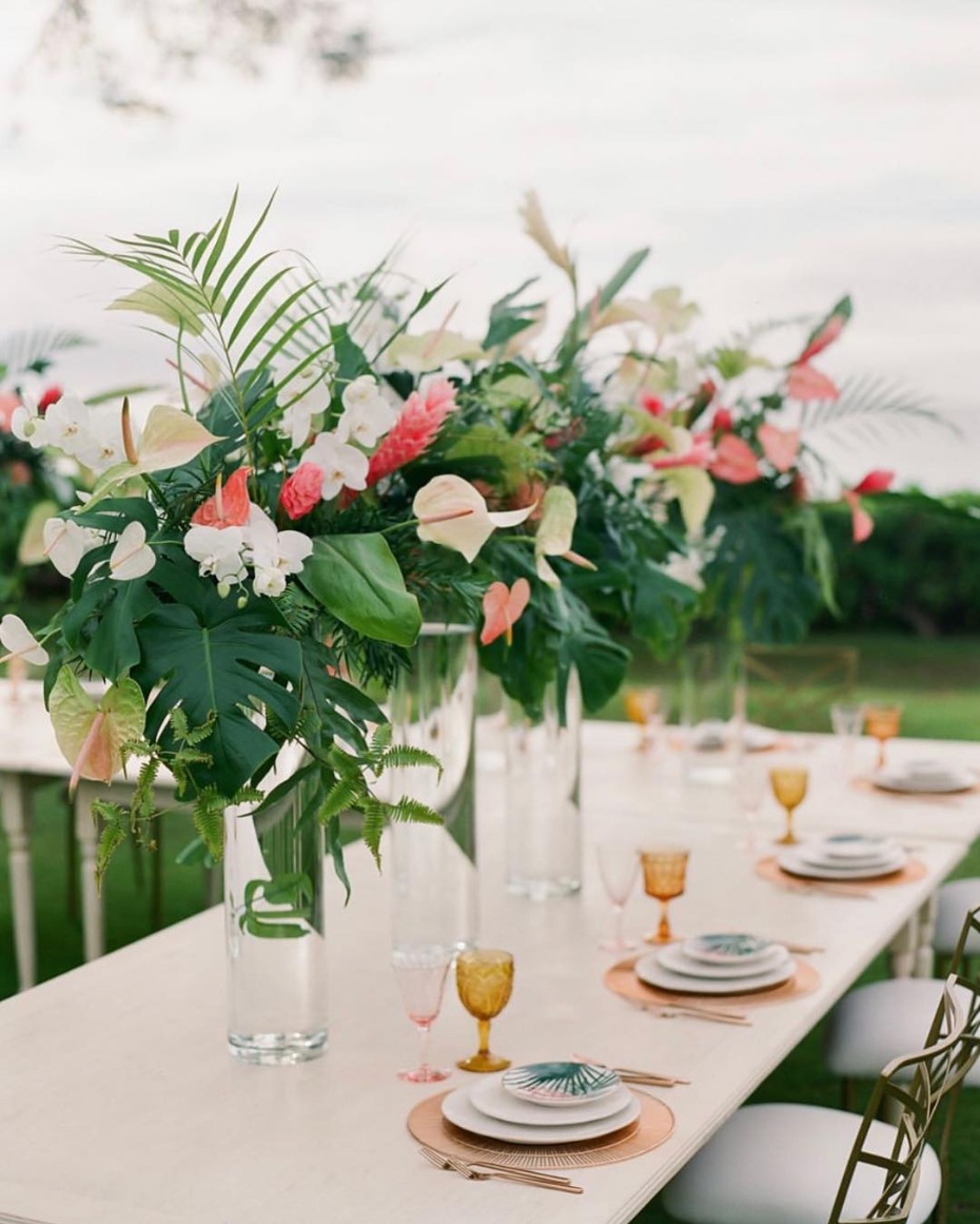 Tropical wedding centerpiece: pink and white flowers in glass vases
