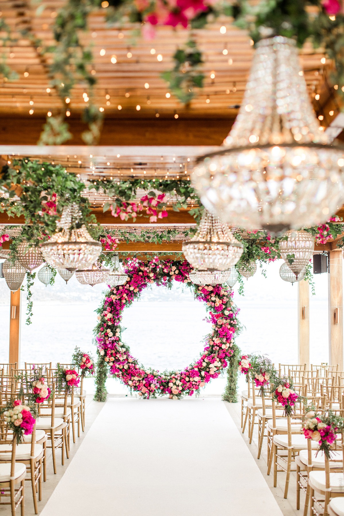 dramatic chandelier and floral wedding ceremony decor