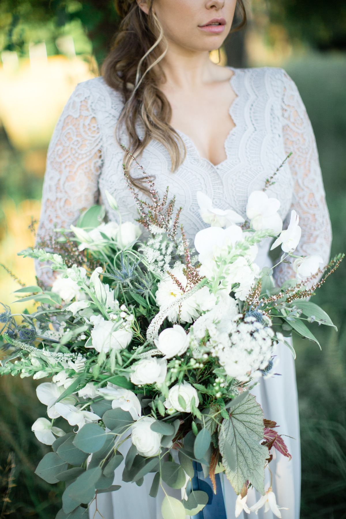 Bride holding a white floral bouquet, elegant wedding style