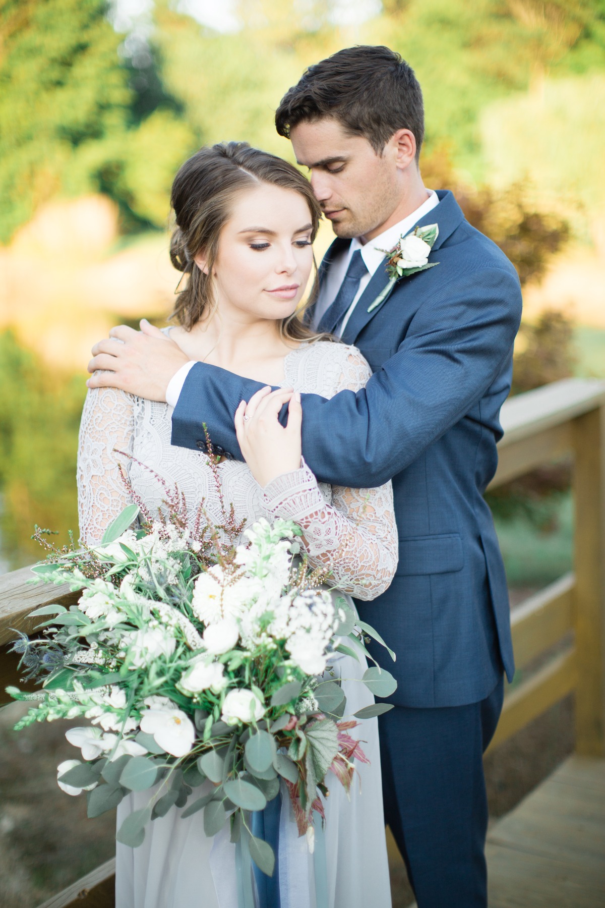 A loving couple on their wedding day, embracing tenderly with flowers