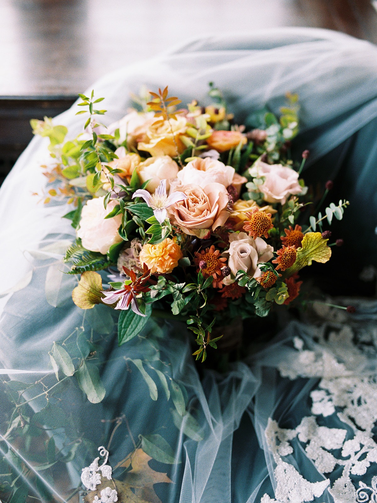 Autumnal wedding bouquet with peach and rust roses