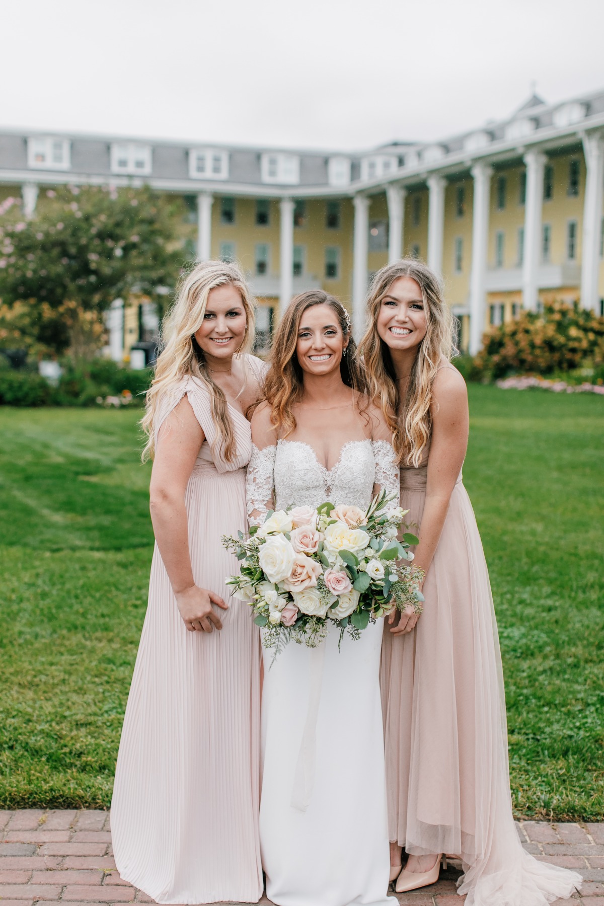 Bridesmaids in mismatched blush dresses