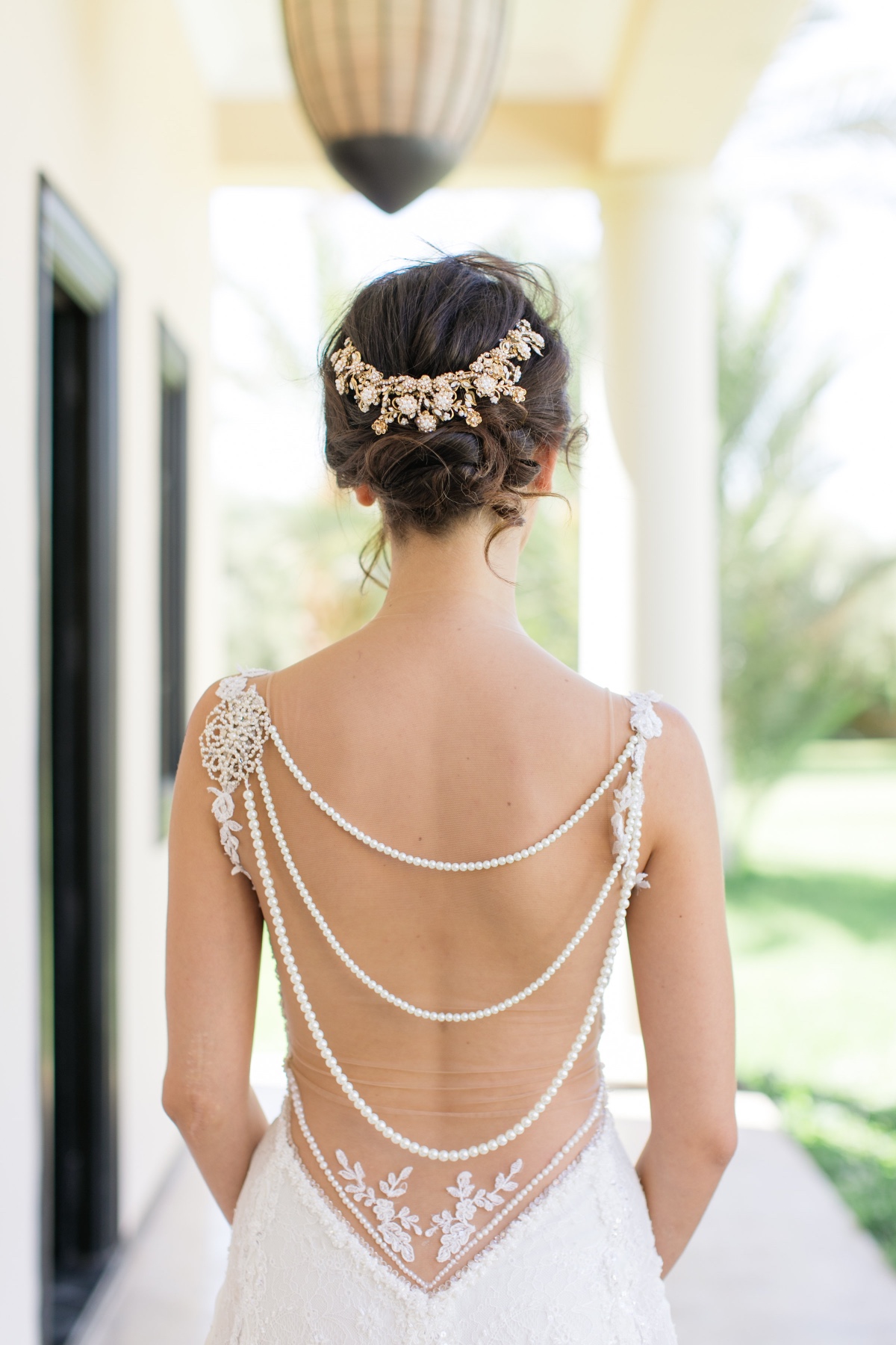 Back view of bride in elegant pearl and lace wedding dress
