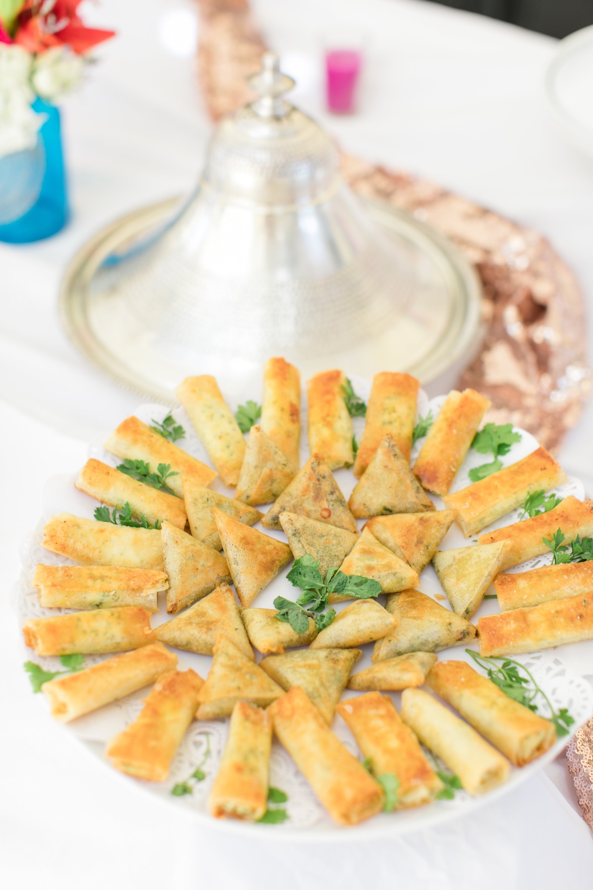 Moroccan appetizers on a plate with tagine pot in background