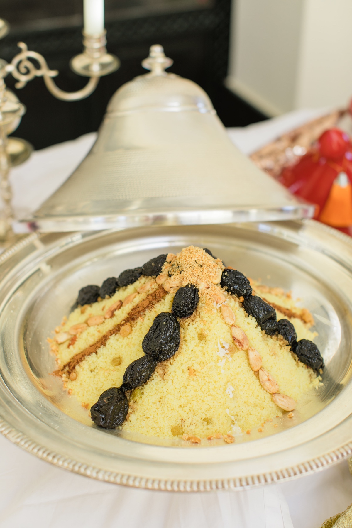 Moroccan couscous with prunes almonds and silver dish