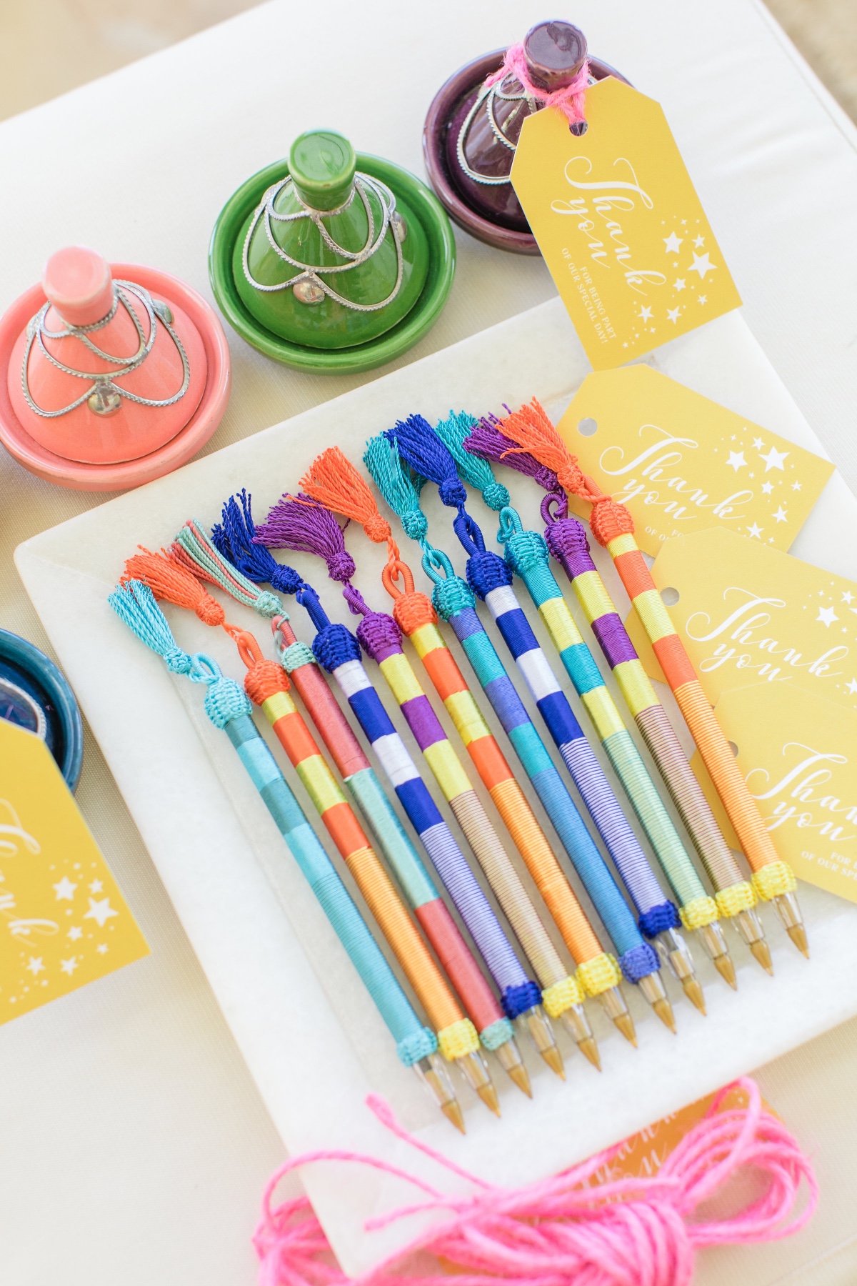 Colorful pens and tagines wedding favors closeup view