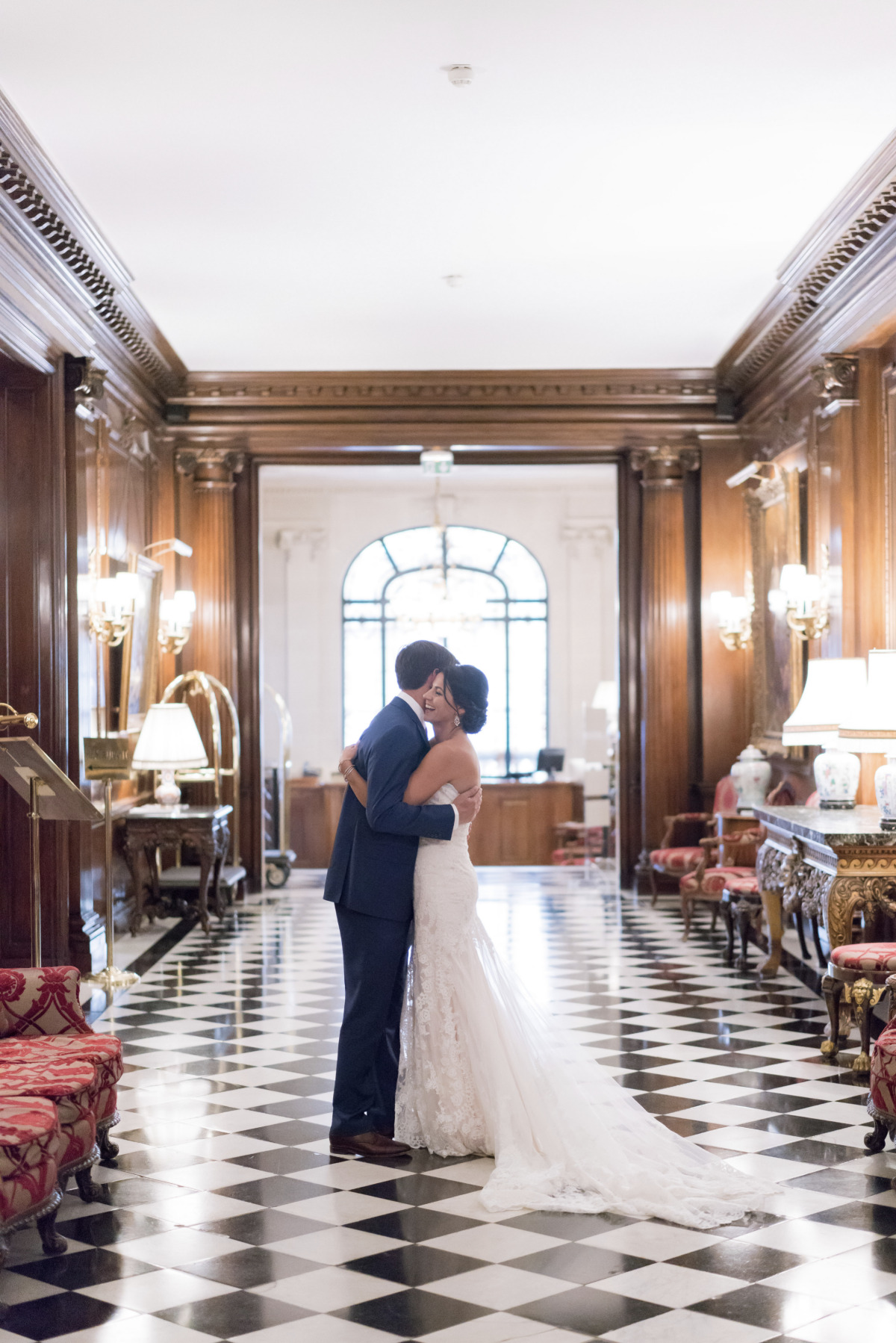 Bride and groom embrace in a hotel lobby wedding photo