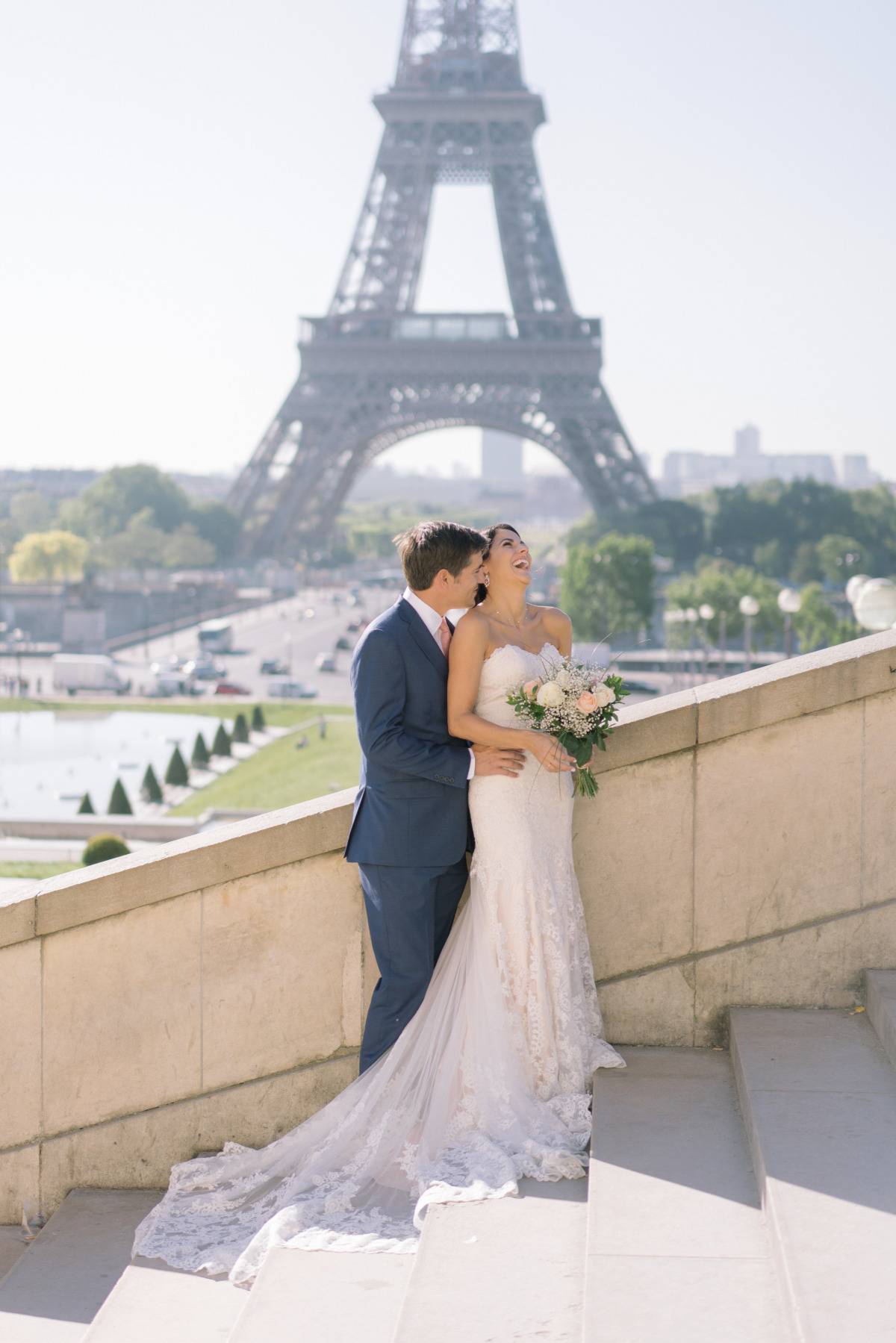 Paris wedding: Bride and groom embrace near Eiffel Tower