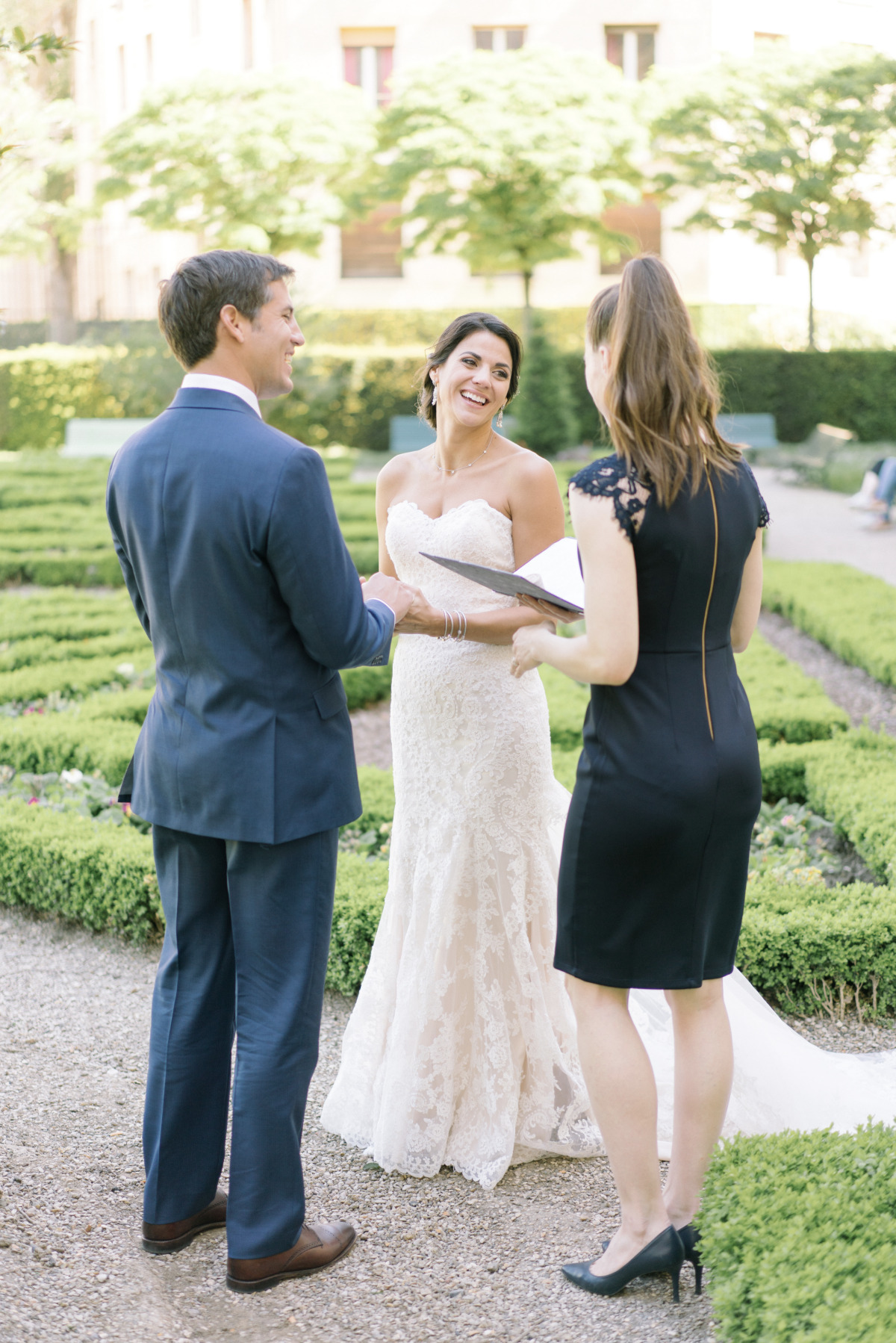 Bride and groom exchanging vows in garden ceremony