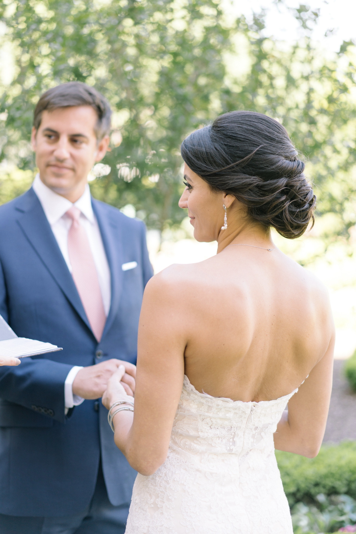Bride and groom exchanging vows at outdoor wedding ceremony