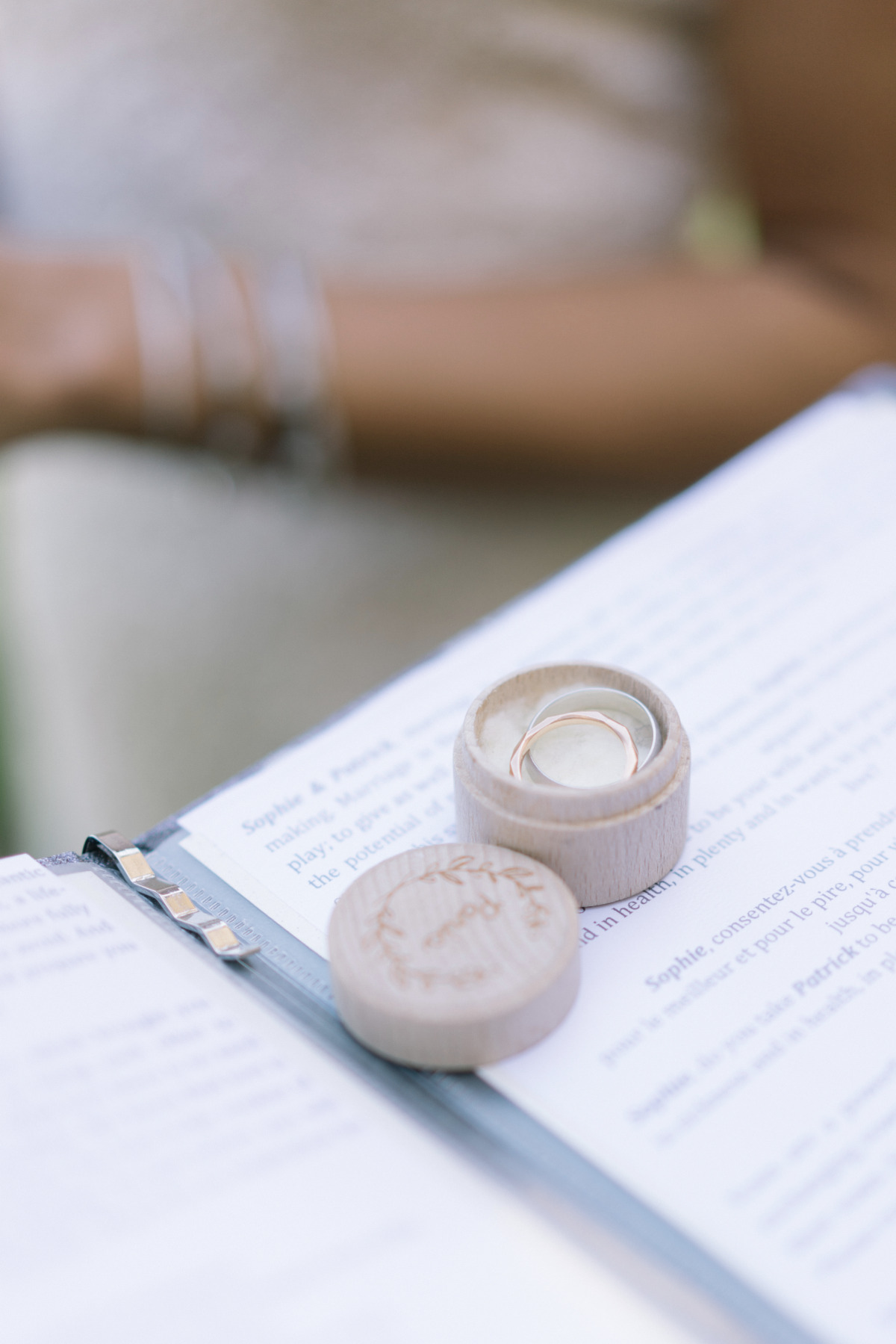 Wedding rings in rustic wooden box on ceremony book