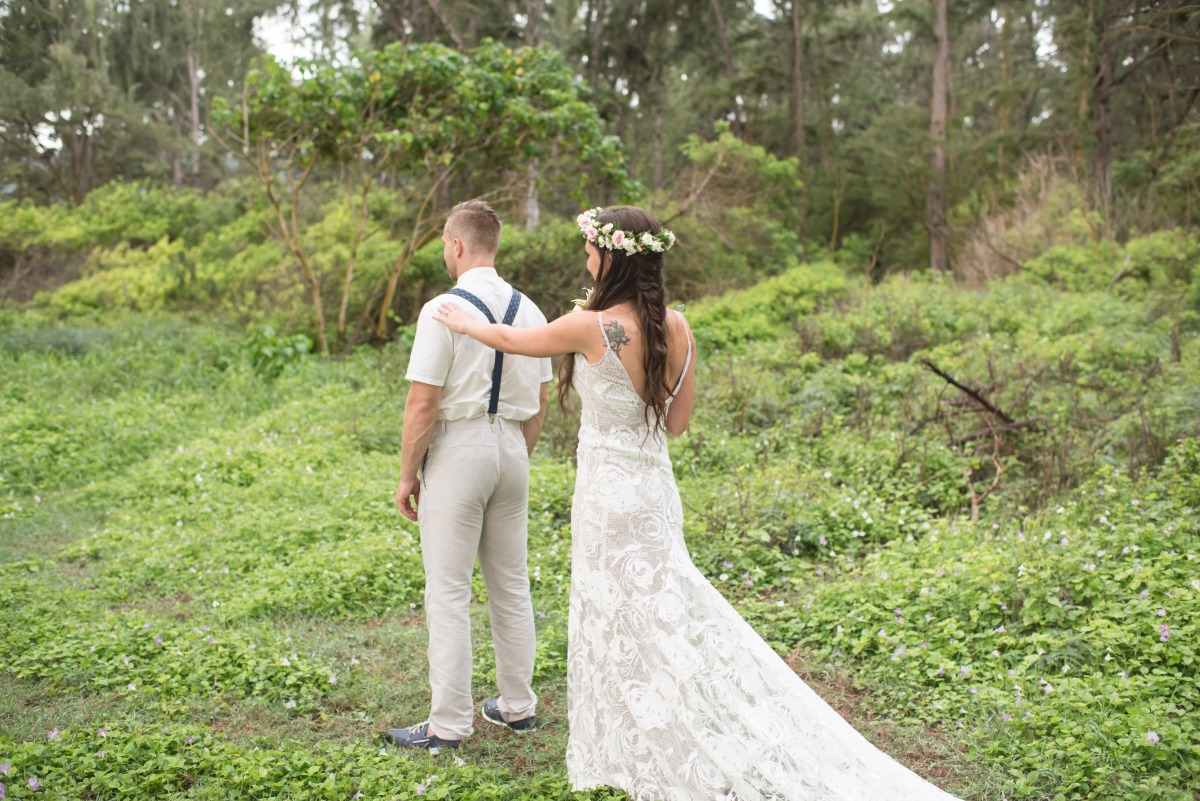 Bride taps groom on shoulder for first look in forest