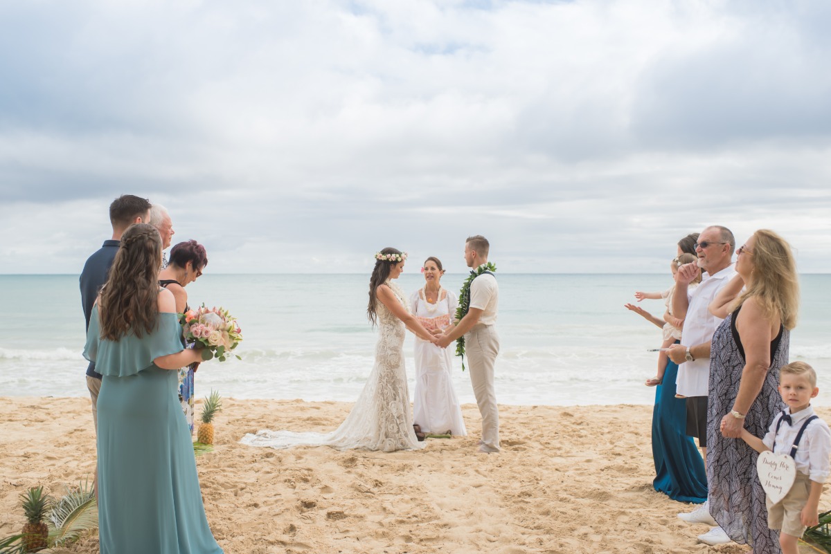 Beach wedding ceremony with bride and groom exchanging vows