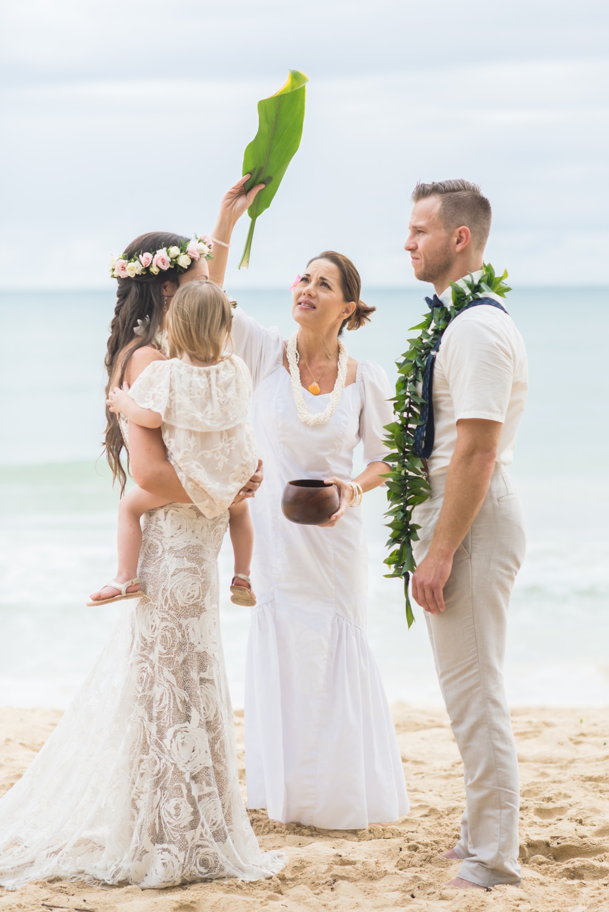 Beach wedding ceremony with bride and groom on a sunny day