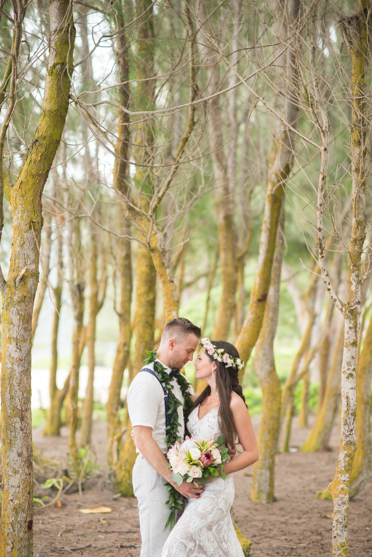 Bride and groom embrace in a forest wedding portrait