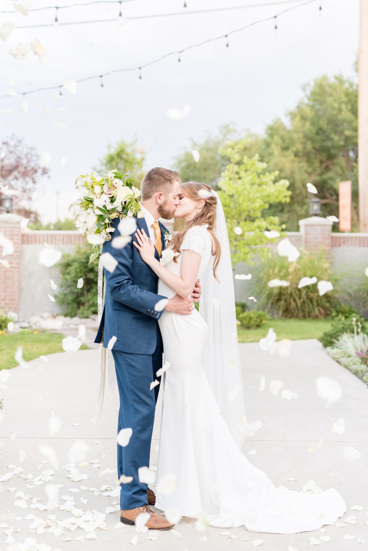 wedding kiss with flower petal toss