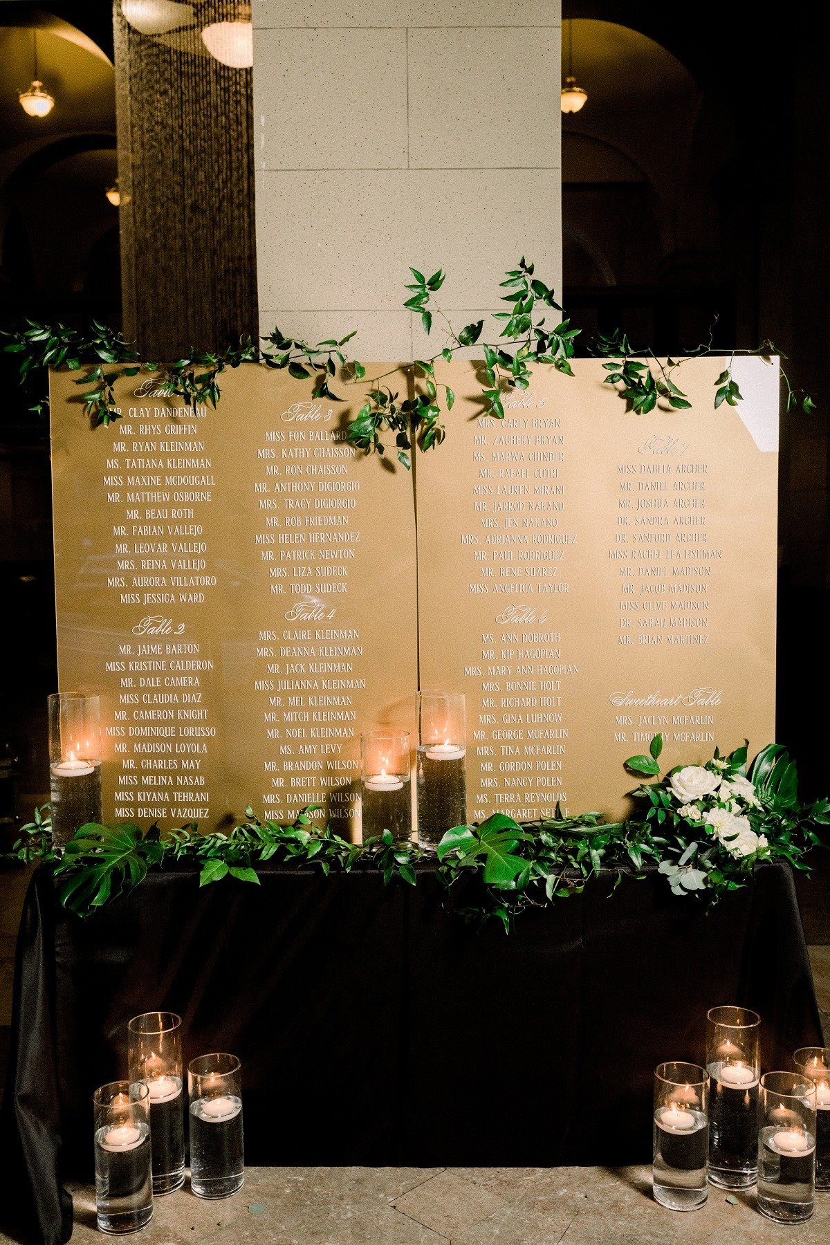 Gold seating chart with greenery