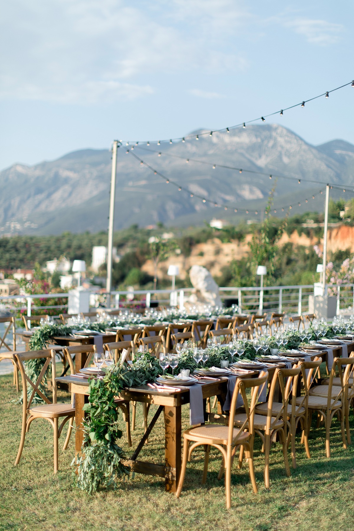 Rustic outdoor wedding reception tablescape with mountain view