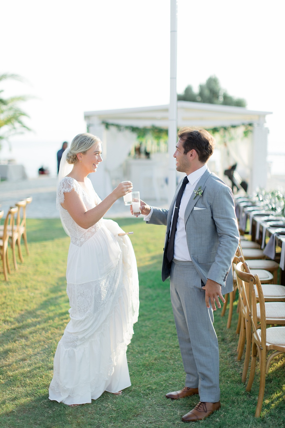 Happy bride and groom toasting at wedding reception