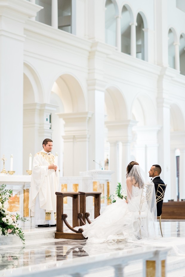Bride and groom during wedding ceremony in white church