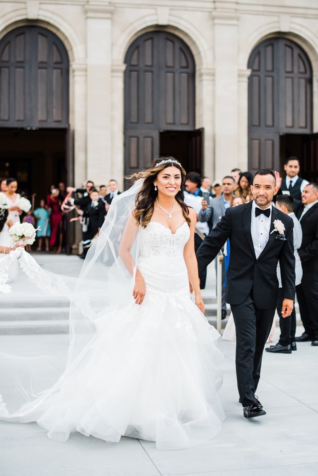 Bride and groom exit church after wedding ceremony