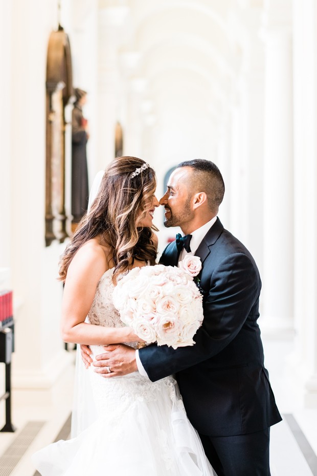 Happy newlyweds embracing at their beautiful church wedding