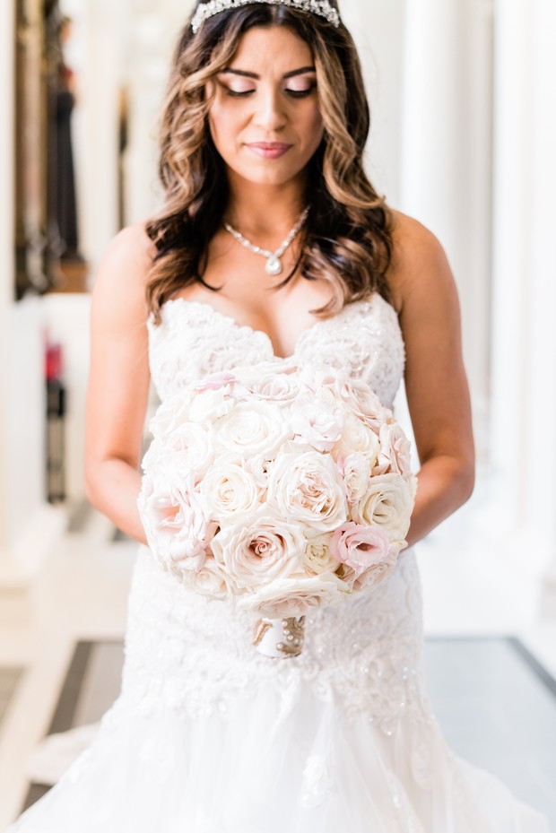 Bride holding a beautiful blush and white rose bouquet