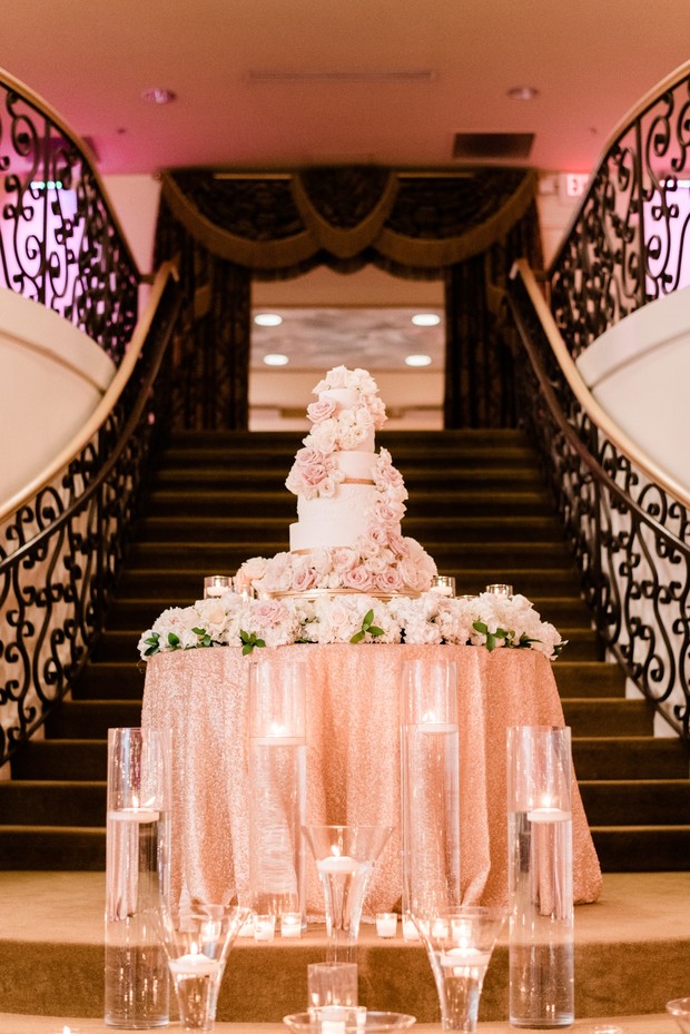 Elegant wedding cake with floral decorations and candles