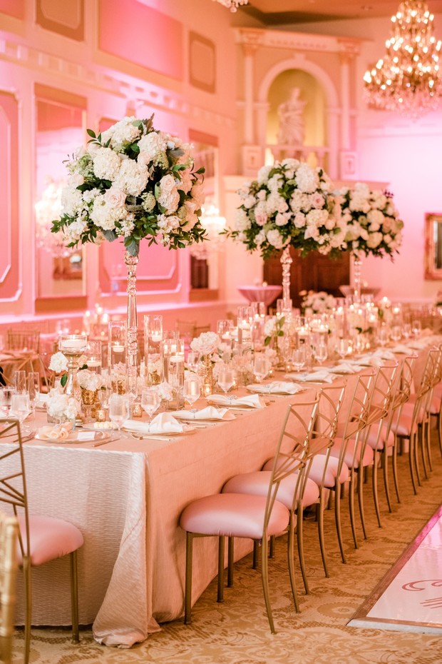 Elegant wedding reception with tall floral centerpieces