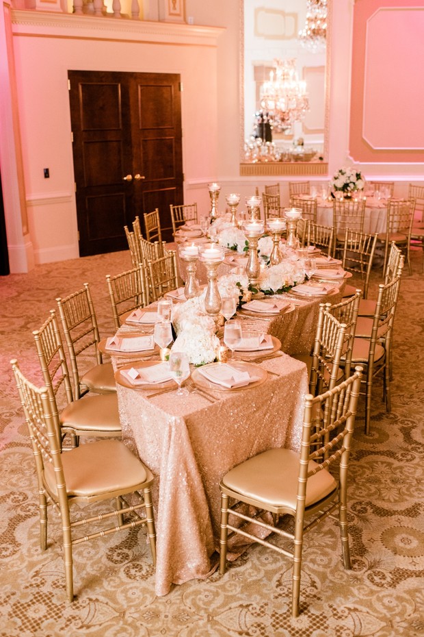 Elegant banquet hall with a long table and gold chairs