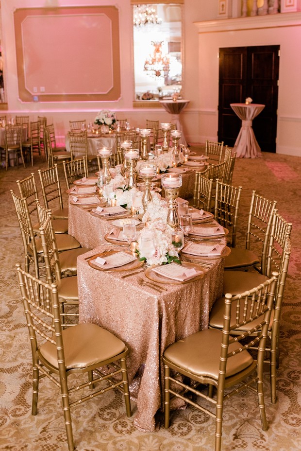 Elegant wedding reception with gold chairs and rose tablecloth