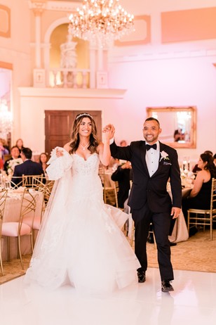 Bride and groom entering wedding reception ballroom