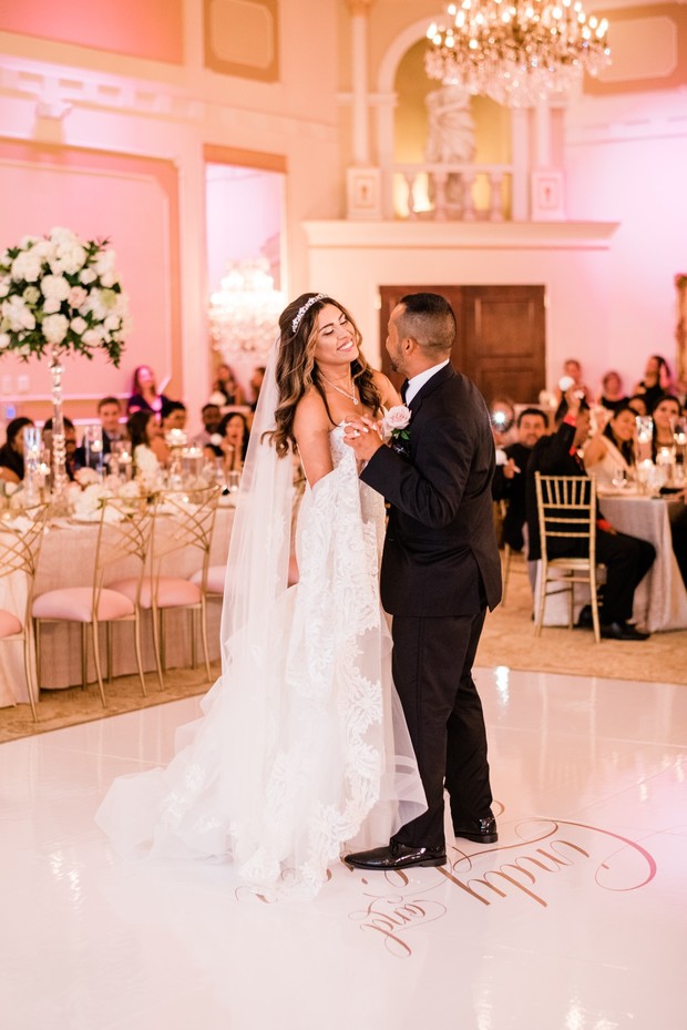 Bride and groom's first dance in elegant ballroom setting