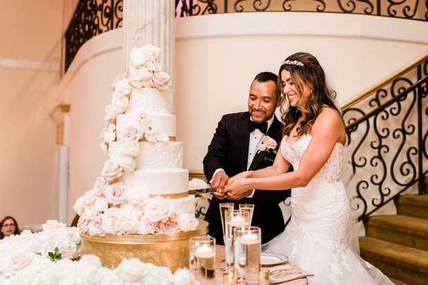 Bride and groom cut their floral wedding cake