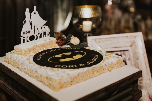 Batman themed wedding cake with custom topper and a Batman logo