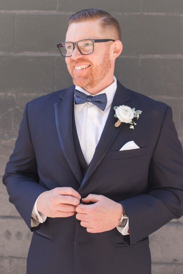 groom in three piece navy suit
