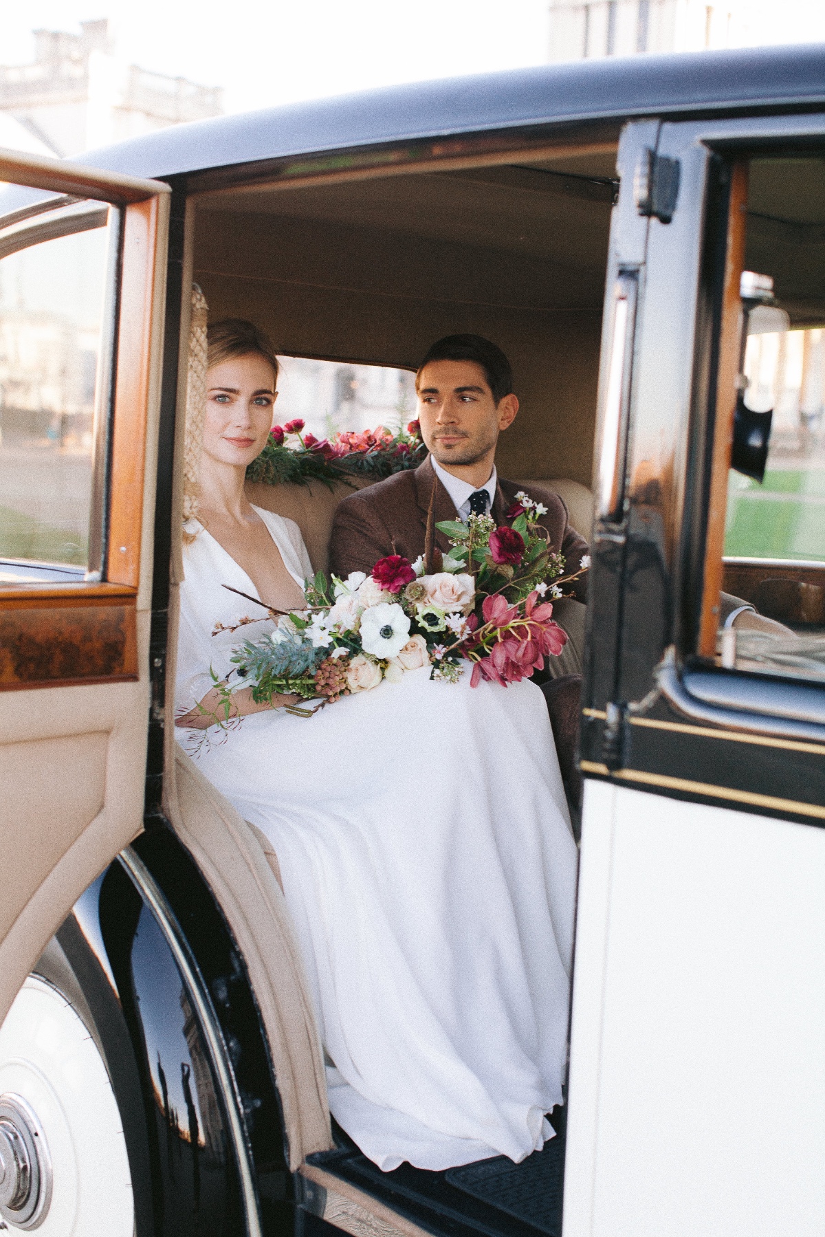 Elegant bride and groom in vintage car