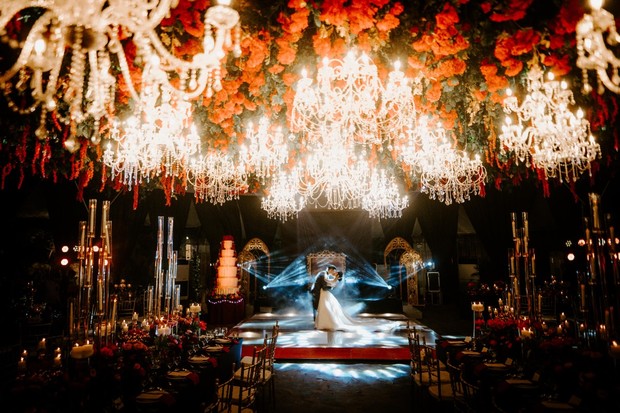 dramatic chandelier and flower ceiling wedding reception