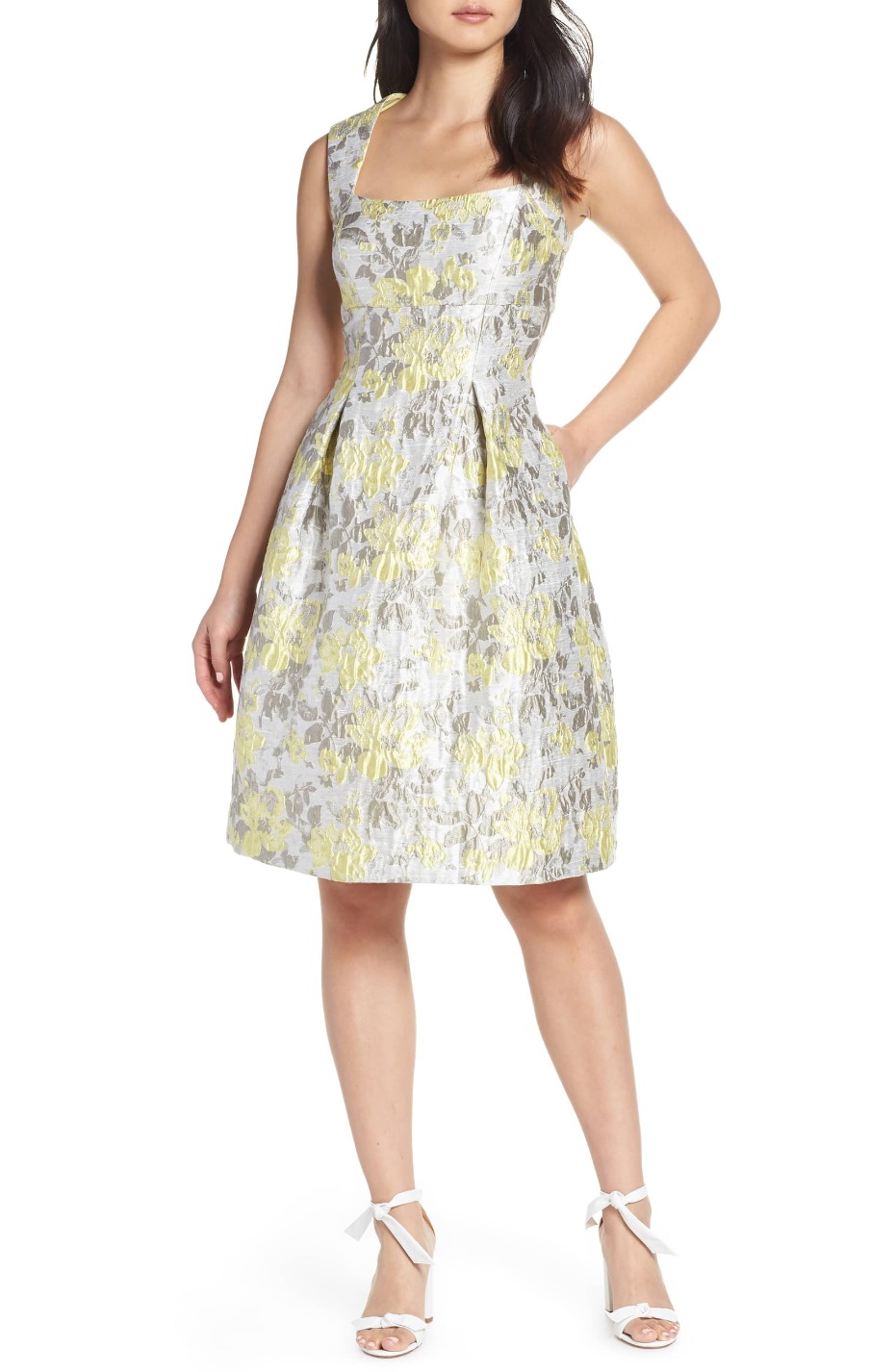 Woman wearing a sleeveless floral brocade midi dress